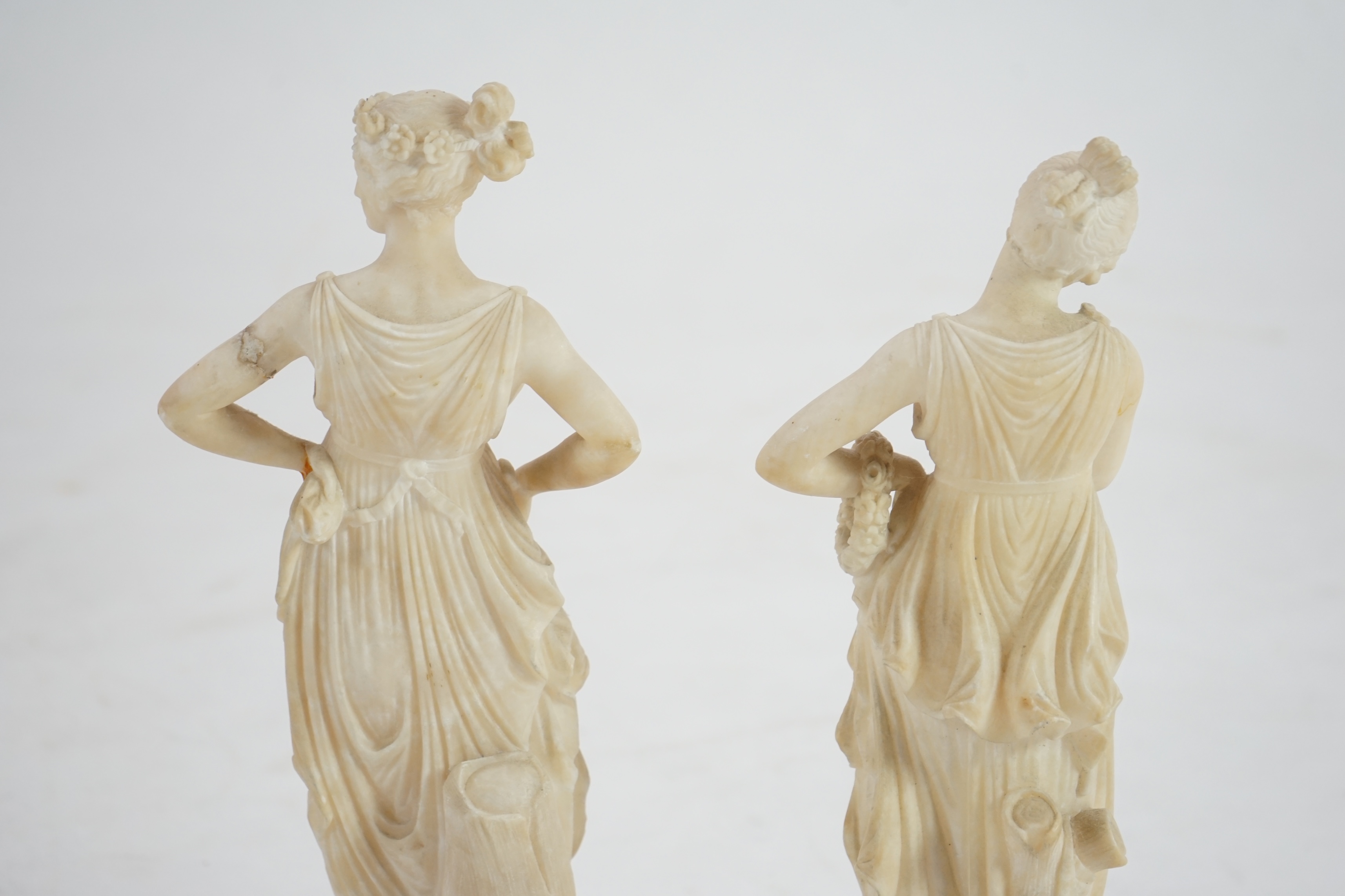 After the antique, a pair of 19th century Italian carved alabaster figures of muses